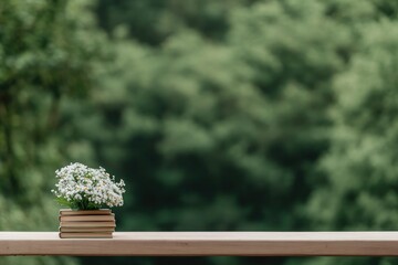 Fototapeta premium scenic park bench with small stack of books and bouquet of fresh flowers on may day morning blurred natural background