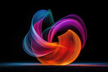 Colorful light trails creating abstract shape on black background