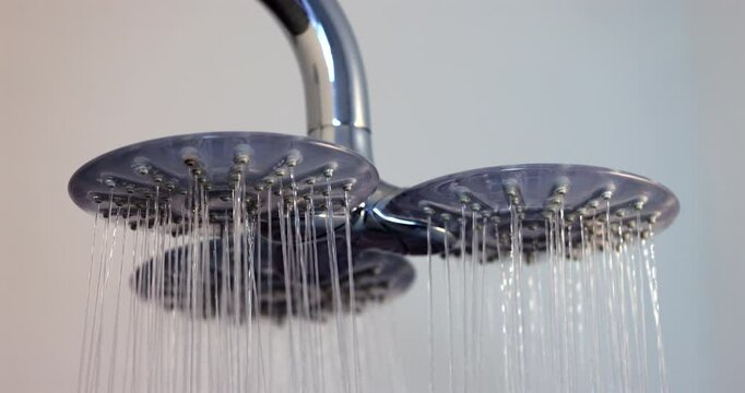 Modern Triple-Head Shower Spraying Streams of Clear Running Water