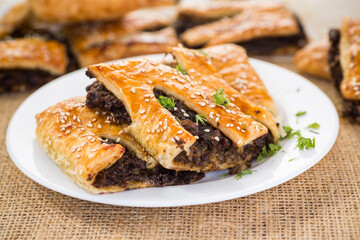Golden puff pastries with mushroom filling and sesame seeds