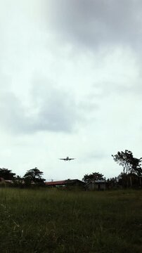 The plane descends while landing in the tropics in cloudy weather
