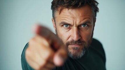 A powerful portrait of a man aggressively pointing with a fierce expression, highlighting strong emotions and commanding presence, emphasizing authority in the moment.