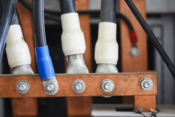 electrical connection.a black electrical wire with a white and blue sheath at the end is connected...