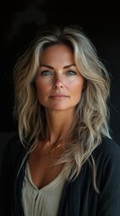 Fototapeta premium A woman with long blonde hair and a necklace is smiling for the camera