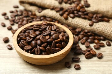 Bowl with coffee beans on wooden background