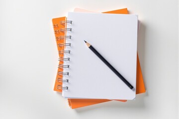 Spiral-bound notebooks with blank white cover and orange accents on a light background. Concept of clean presentation and product layout. Ai generative