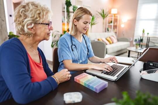 Caring interaction between a nurse and a senior woman in a cozy home setting