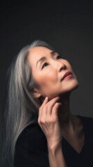 A woman with gray hair is looking up at the camera