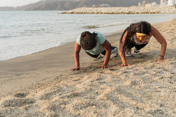 Beach Workout at Dusk: Women Doing Push-Ups by the Sea
