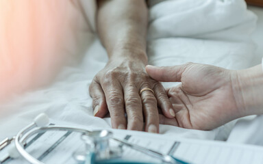 Hospitalized elderly patient senior woman sleeping on bed in hospital ward room with iv medical...