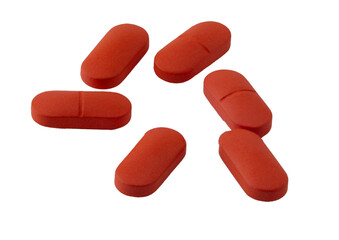 red pills on white background: medication and health
