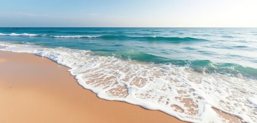 Azure blue ocean waves lapping a sunny, sandy beach , seascape, peaceful