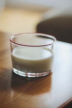 Close-up of a glass of milk on a wooden table