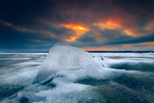 Ice formations on a Baltic Sea winter beach at sunset, Lithuania