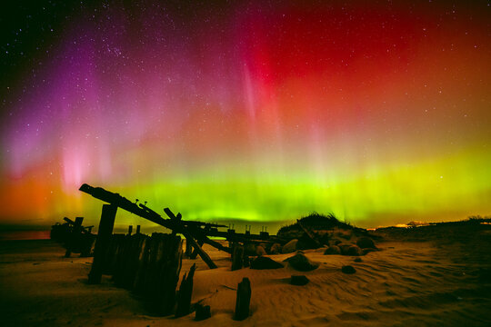 Pink and green northern lights over Sventoji old pier (Sventosios senasis molas), Sventoji, Palanga, Lithuania