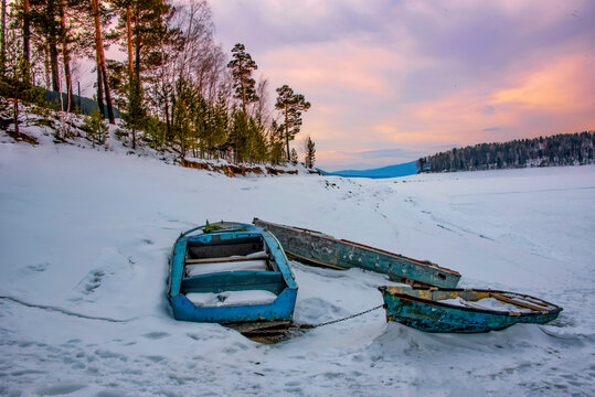 Three Wooden boats on the Frozen Yenisei River, Krasnoyarsk, Siberia, Russia