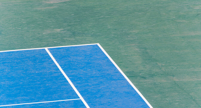 Close-up detail of the corner of a blue outdoor tennis court
