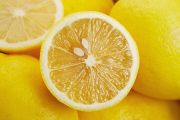Full frame close-up of a halved lemon on a stack of lemons