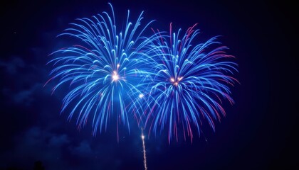 Fototapeta premium A stunning photograph capturing vibrant blue fireworks exploding in the night sky, illuminating the darkness with their intense bursts of color and bright trails of light.