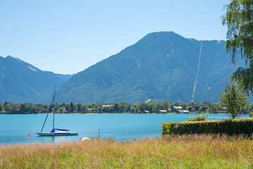 idyllic scenery lake Tegernsee with sailboat, view to Wallberg mountain, bavaria