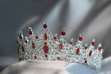 Royal crown with red gemstones, garnets for queen and princess