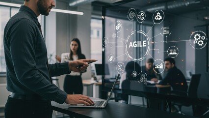 Middle aged man pointing at digital display in modern office with female colleague behind Focus on agile methodology, teamwork, technology