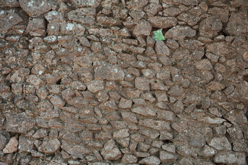 Ancient wall texture background with old stone bricks and window hole