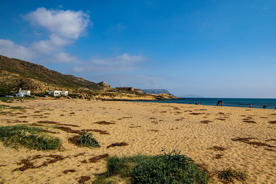 Sandy Beach with Coastal Fortress in the Distance
