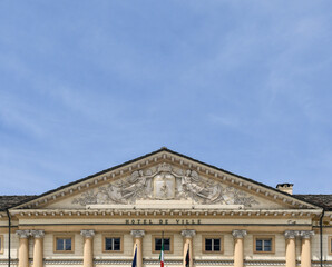 High-section of the Hotel de Ville, the Neoclassical town hall of Aosta, with the coat of arms between two angels on the tympanum, Aosta Valley, Italy
