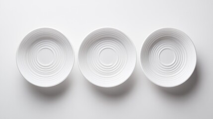 Obraz premium Three white bowls on white background
