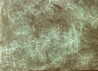 Weathered copper surface showing patina formation and corrosion effects
