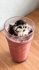 Red velvet frappe with sprinkled choco topping, milk and ice blend together with whip cream and cinnamon