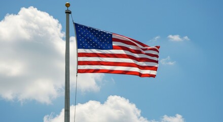 American Flag Waving Proudly Against a Backdrop of a Blue Sky and Clouds