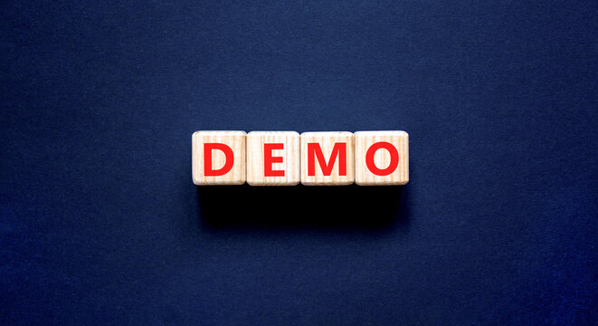 Demo symbol. Concept word Demo on beautiful wooden blocks. Beautiful black table black background. Business and demo concept. Copy space.