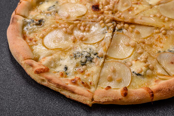 Delicious sweet pizza with pear, gorgonzola cheese and nuts