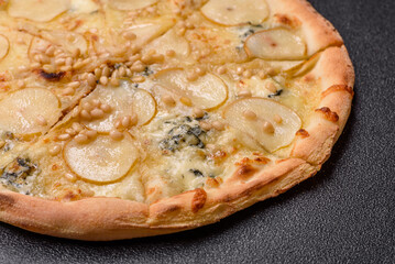 Delicious sweet pizza with pear, gorgonzola cheese and nuts