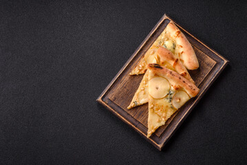 Delicious sweet pizza with pear, gorgonzola cheese and nuts