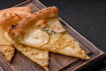 Delicious sweet pizza with pear, gorgonzola cheese and nuts