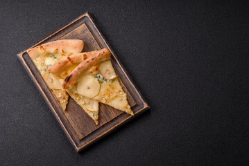 Delicious sweet pizza with pear, gorgonzola cheese and nuts