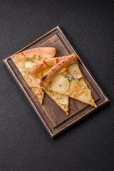 Delicious sweet pizza with pear, gorgonzola cheese and nuts