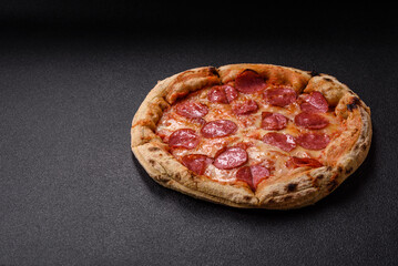 Pepperoni pizza with sausage, cheese, tomatoes, salt and spices