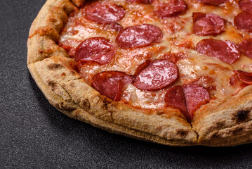 Pepperoni pizza with sausage, cheese, tomatoes, salt and spices