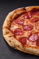 Pepperoni pizza with sausage, cheese, tomatoes, salt and spices