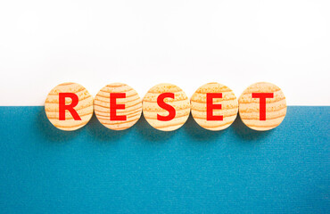 Reset symbol. Concept word Reset on beautiful wooden circles. Beautiful white and blue background....