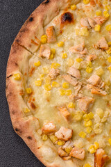 Hawaiian pizza with chicken, pineapple, corn and cheese