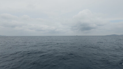 Side view from boat in Indian ocean sailing between Seychelles islands before storm