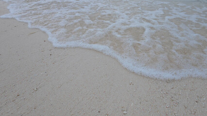 Closeup shot of waves on Seychelles beach with white sand