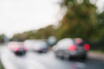 bokeh blur of cars moving on europe city street after rain