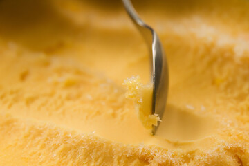scooping with spoon orange sorbet