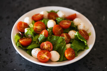 Salad with mozzarella balls tomatoes and mix salad